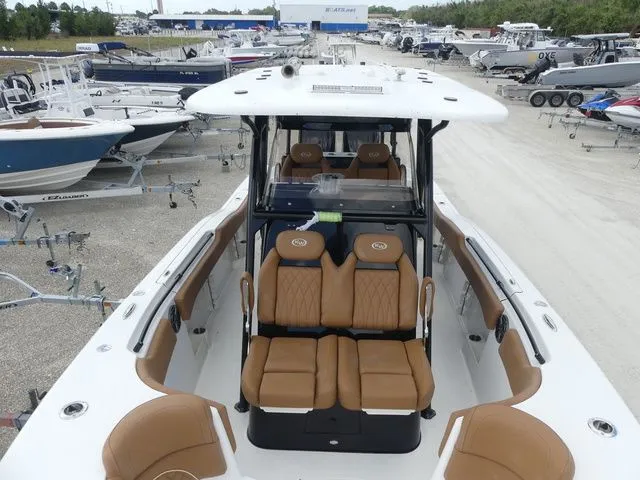 Slide: The Image of Key West 291 FS 2026 boat with brown seats in marina. - 13