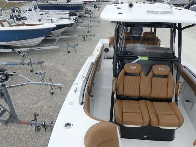 Slide: The Image of 2026 Key West 291 FS boat with brown seats in a parking lot. - 14