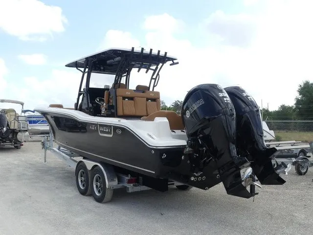 Slide: The Image of 2026 Key West 291 FS boat with dual outboard engines on trailer. - 6