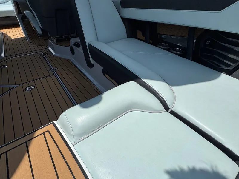Slide: The Image of Interior of 2023 Nautique G23 with white seats and wooden flooring. - 15