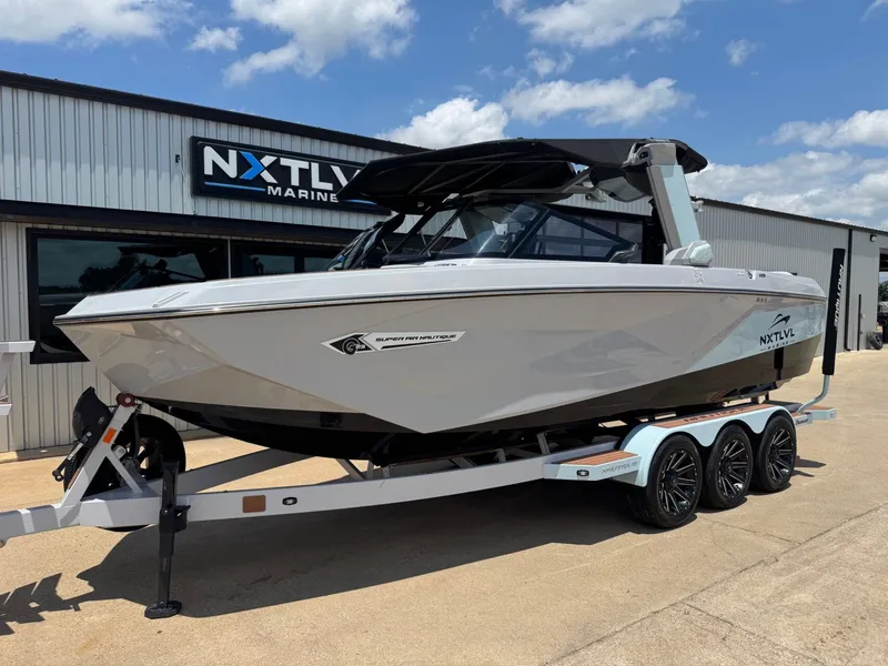 Slide: The Image of 2023 Nautique G23 boat in front of NXT LVL Marine building. - 2