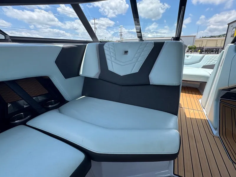 Slide: The Image of Interior of 2023 Nautique G23 with luxurious seating and wood flooring. - 20