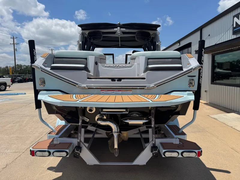 Slide: The Image of Rear view of a 2023 Nautique G23 boat on a parking lot. - 6
