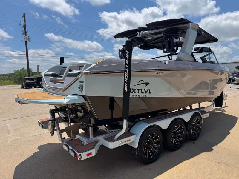 Slide: The Image of 2023 Nautique G23 boat on trailer in sunny weather. - 7