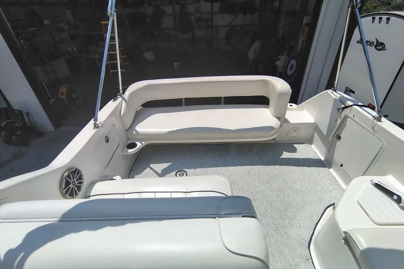 Slide: The Image of Interior view of a 1995 Sea Ray 250 Sundancer boat with white seating and carpet. - 4
