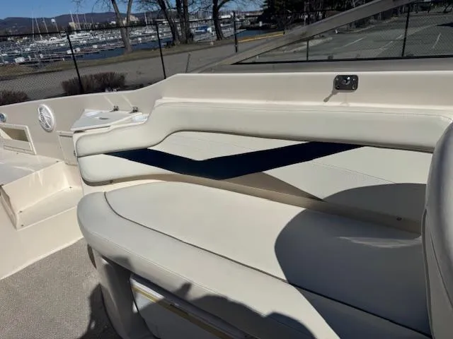 Slide: The Image of 2003 Rinker 282 Captiva Cuddy boat interior with white seating and blue accent. - 11