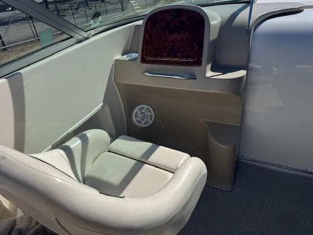 Slide: The Image of 2003 Rinker 282 Captiva Cuddy interior with beige seating and dashboard. - 13