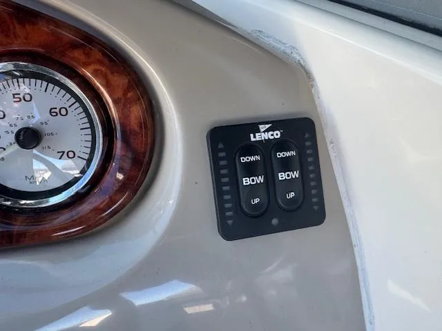 Slide: The Image of Control panel of a 2003 Rinker 282 Captiva Cuddy boat with Lenco trim tab switches. - 15