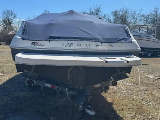 Slide: The Image of 2003 Rinker 282 Captiva Cuddy boat with cover, parked on grass. - 3