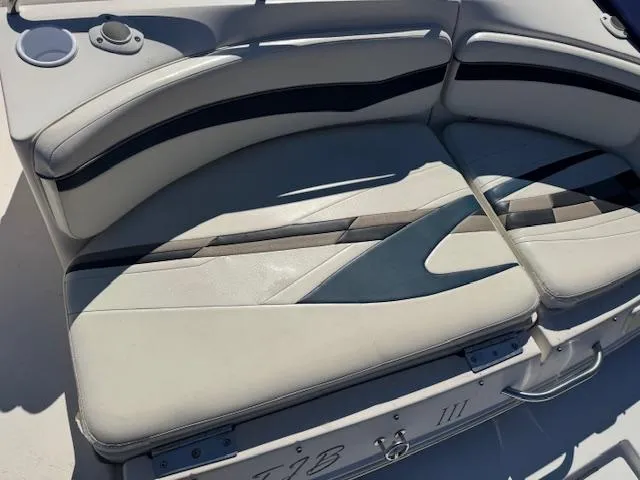 Slide: The Image of 2003 Rinker 282 Captiva Cuddy boat seating with cup holder and storage compartment. - 5
