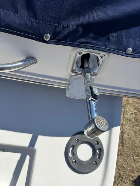 Slide: The Image of 2003 Rinker 282 Captiva Cuddy boat detail with chrome hardware and blue cover. - 6