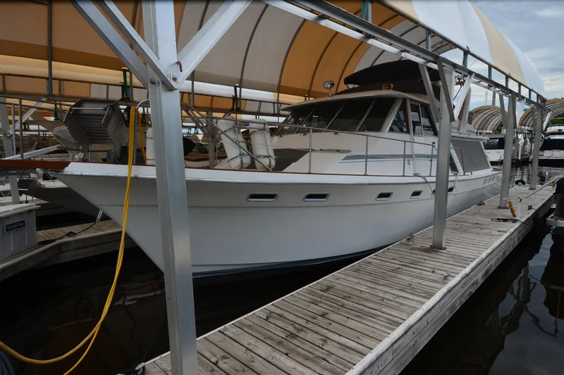 Slide: The Image of 1989 Bayliner 4518 Motoryacht docked under covered marina. - 1