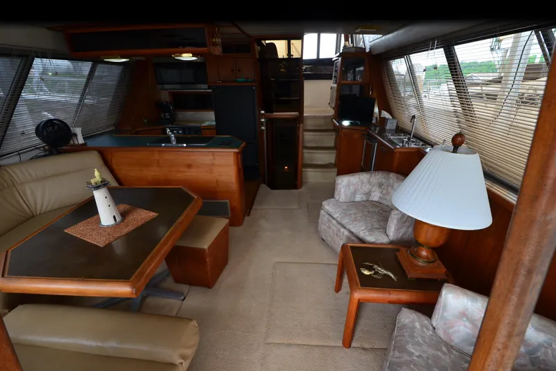 Slide: The Image of Interior of 1989 Bayliner 4518 Motoryacht with cozy seating, dining area, and kitchenette. - 10