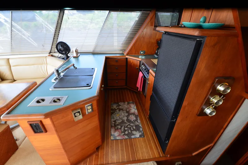Slide: The Image of Interior of 1989 Bayliner 4518 Motoryacht kitchen with wood cabinetry and modern appliances. - 14