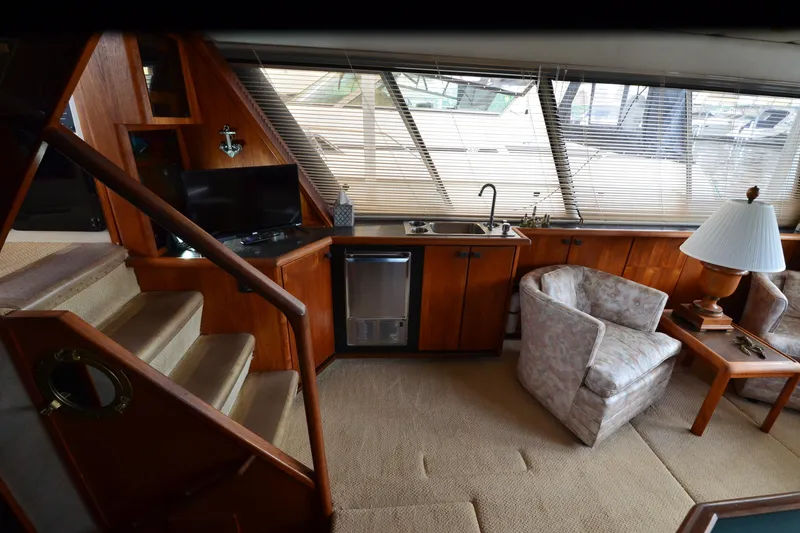 Slide: The Image of Interior of 1989 Bayliner 4518 Motoryacht with cozy seating, kitchenette, and natural light. - 15