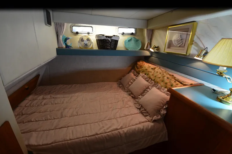 Slide: The Image of Cozy bedroom interior of 1989 Bayliner 4518 Motoryacht with elegant decor and soft lighting. - 16