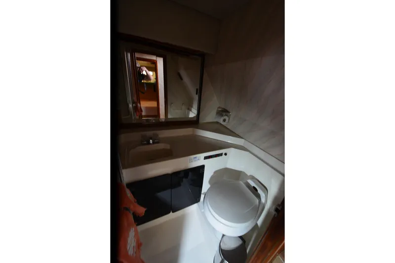 Slide: The Image of Bathroom interior of 1989 Bayliner 4518 Motoryacht with sink and toilet. - 17