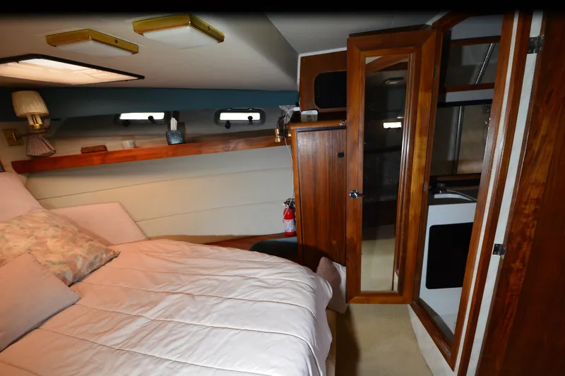 Slide: The Image of Cozy bedroom in 1989 Bayliner 4518 Motoryacht with wood accents and natural light. - 20