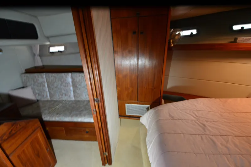 Slide: The Image of Interior of 1989 Bayliner 4518 Motoryacht with wood cabinetry and cozy seating area. - 21