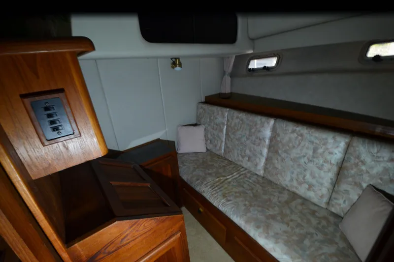 Slide: The Image of Interior of 1989 Bayliner 4518 Motoryacht with cozy seating and wooden cabinetry. - 23