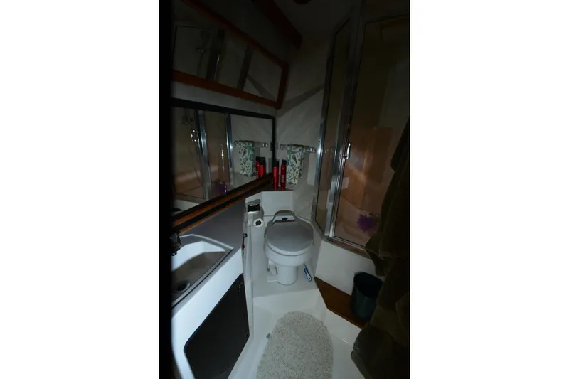 Slide: The Image of Bathroom interior of 1989 Bayliner 4518 Motoryacht with toilet, sink, and shower. - 26