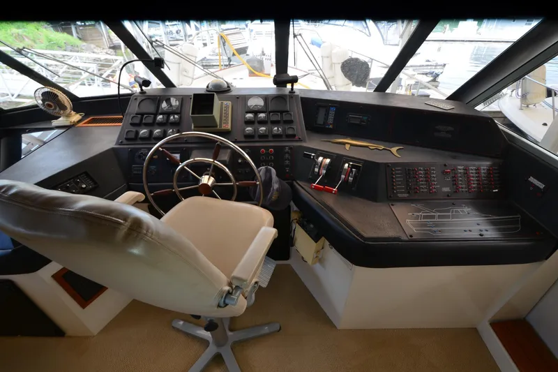 Slide: The Image of Cockpit of 1989 Bayliner 4518 Motoryacht with steering wheel and control panels. - 30