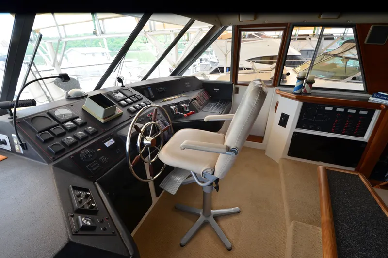 Slide: The Image of 1989 Bayliner 4518 Motoryacht helm with steering wheel and control panel. - 33