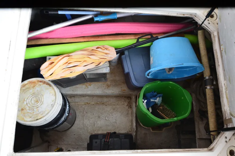 Slide: The Image of Storage compartment of 1989 Bayliner 4518 Motoryacht with buckets and pool noodles. - 43