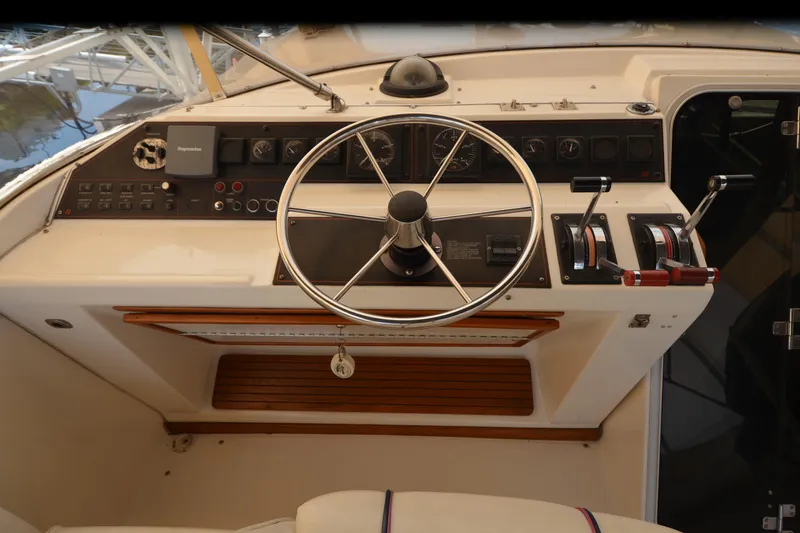 Slide: The Image of 1989 Bayliner 4518 Motoryacht helm with steering wheel and control panel. - 46
