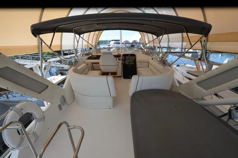 Slide: The Image of 1989 Bayliner 4518 Motoryacht interior with white seating and covered helm station. - 48