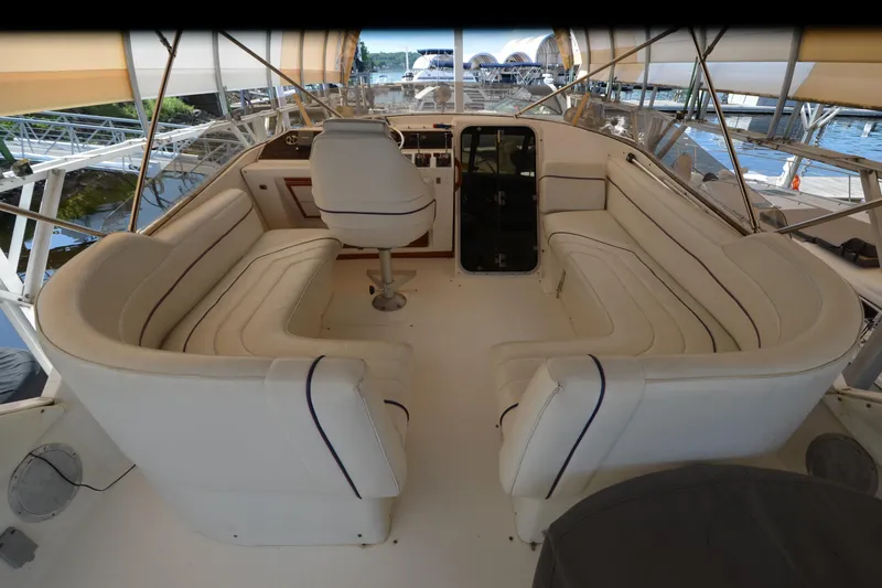 Slide: The Image of 1989 Bayliner 4518 Motoryacht interior with white seating and helm station. - 49