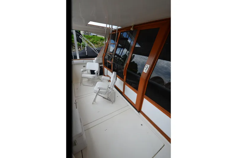 Slide: The Image of 1989 Bayliner 4518 Motoryacht deck with chairs and wooden doors. - 8
