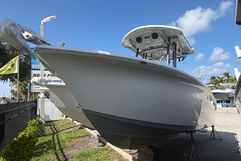 The Image of 2026 Sea Pro 225FLX Sandbar boat displayed outdoors under clear blue sky. - 1