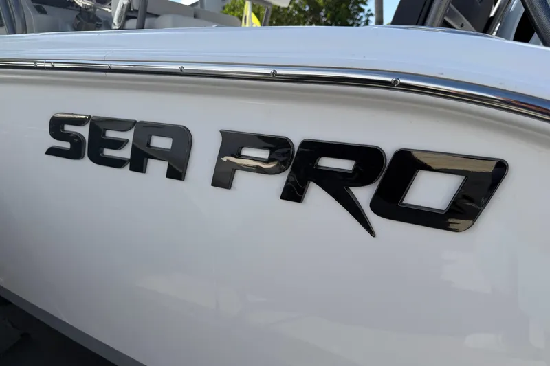 Slide: The Image of 2026 Sea Pro 225FLX Sandbar boat logo on sleek white hull. - 10