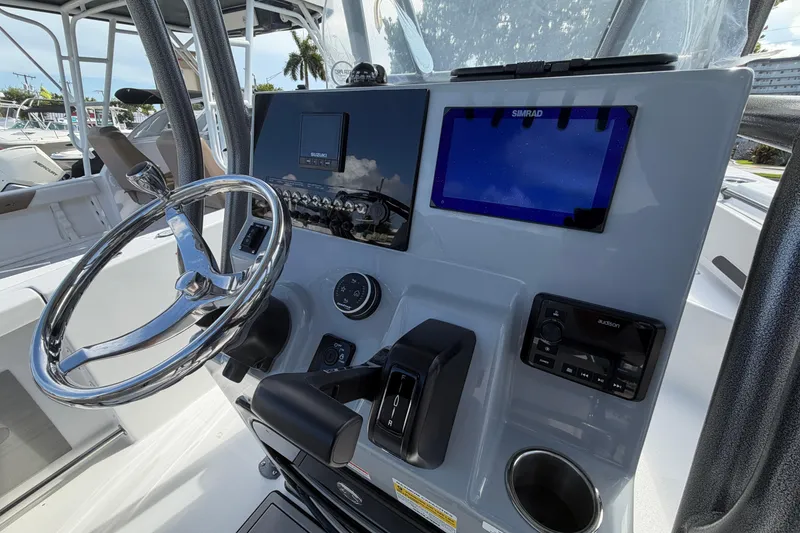 Slide: The Image of Helm of 2026 Sea Pro 225FLX Sandbar boat with modern controls and displays. - 11