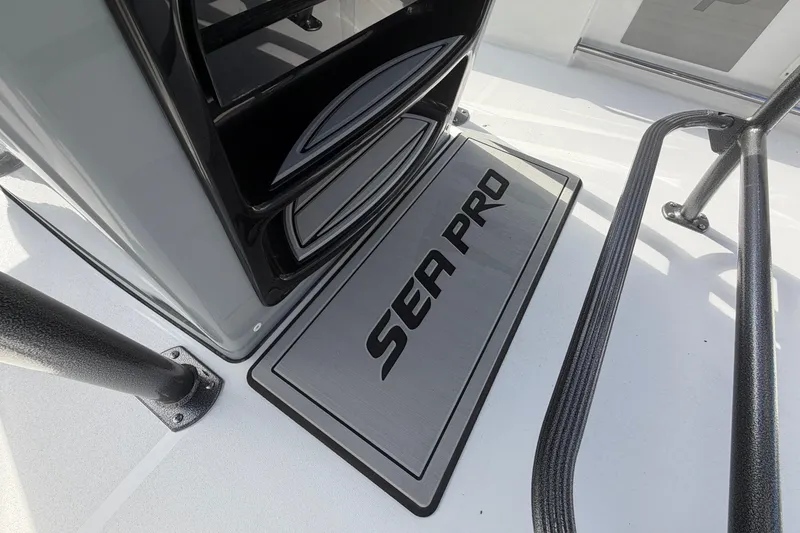 Slide: The Image of 2026 Sea Pro 225FLX Sandbar boat deck with logo and sleek design elements. - 13