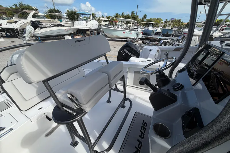 Slide: The Image of 2026 Sea Pro 225FLX Sandbar boat interior with helm, seating, and control panel. - 14