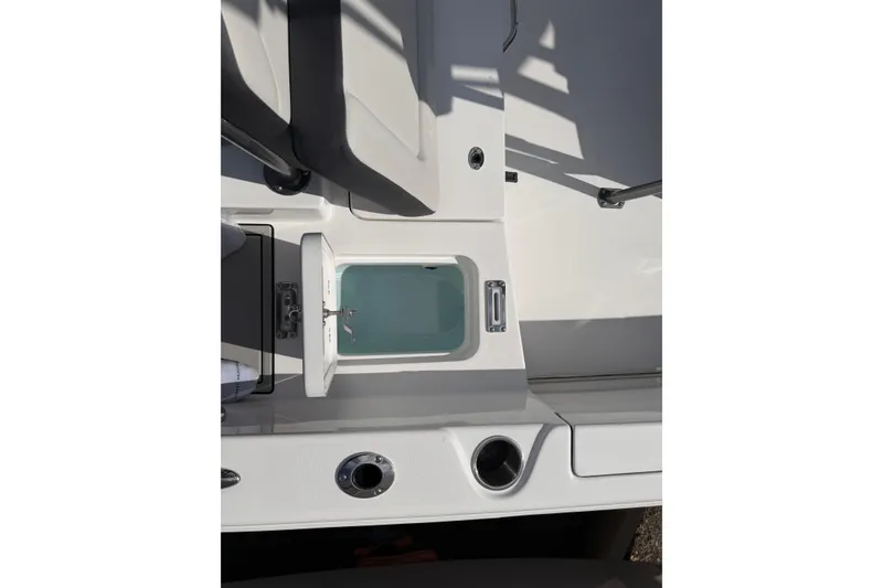 Slide: The Image of 2026 Sea Pro 225FLX Sandbar boat interior with seating and storage compartment. - 18