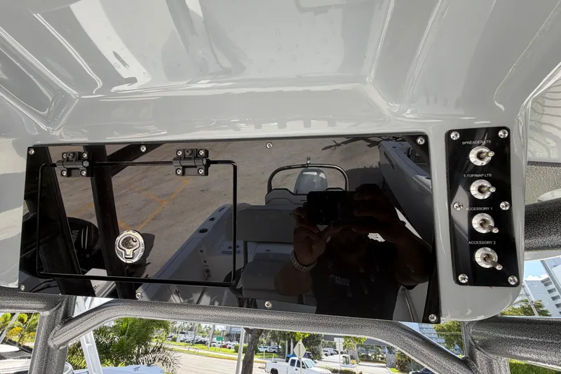 Slide: The Image of Control panel of 2026 Sea Pro 225FLX Sandbar boat with switches and storage compartment. - 21