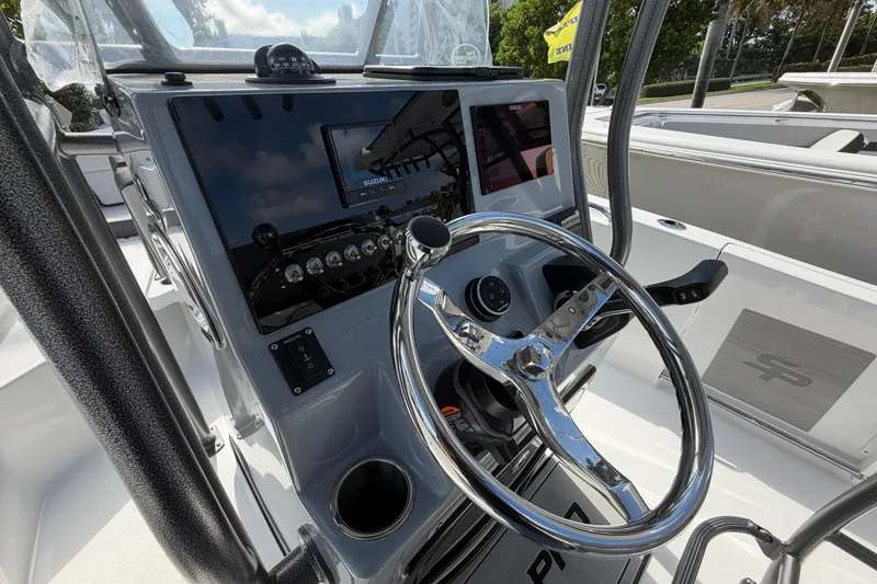 Slide: The Image of 2026 Sea Pro 225FLX Sandbar boat dashboard with steering wheel and control panel. - 22