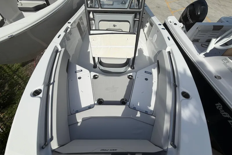 Slide: The Image of 2026 Sea Pro 225FLX Sandbar boat interior with seating and storage compartments. - 25