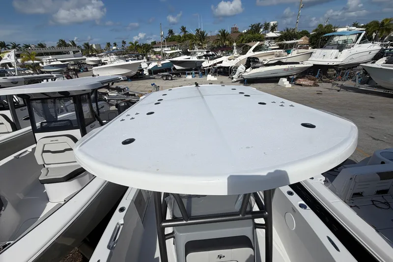 Slide: The Image of 2026 Sea Pro 225FLX Sandbar boat in marina, surrounded by other vessels under a clear sky. - 30