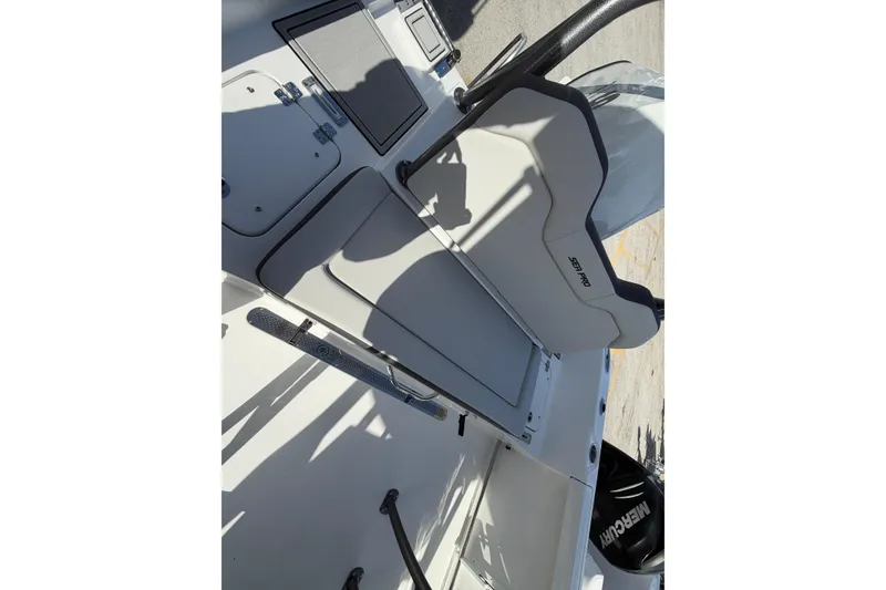 Slide: The Image of 2026 Sea Pro 225FLX Sandbar boat interior with seating and storage compartments. - 32