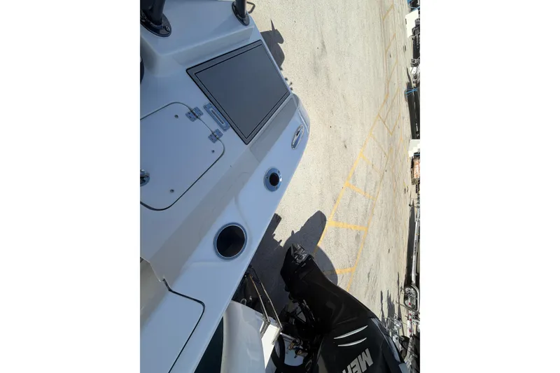 Slide: The Image of 2026 Sea Pro 225FLX Sandbar boat, featuring sleek design and powerful engine, docked outdoors. - 35