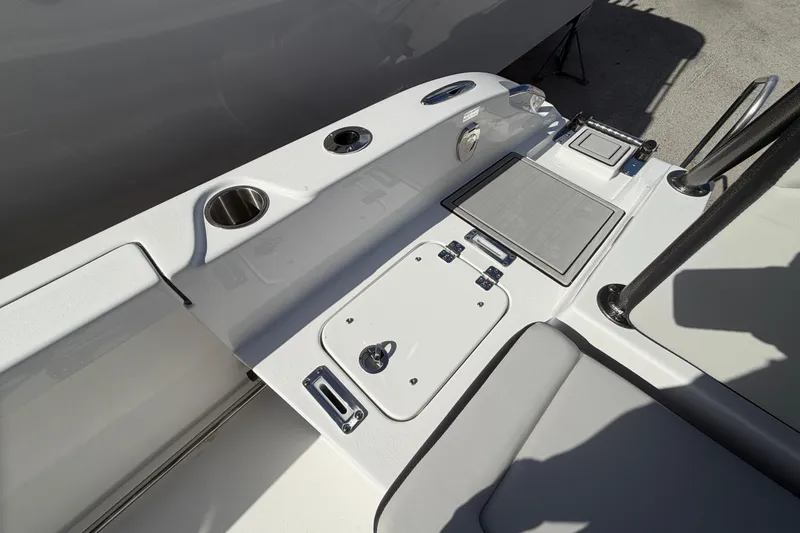 Slide: The Image of 2026 Sea Pro 225FLX Sandbar boat interior with cup holders and seating area. - 36