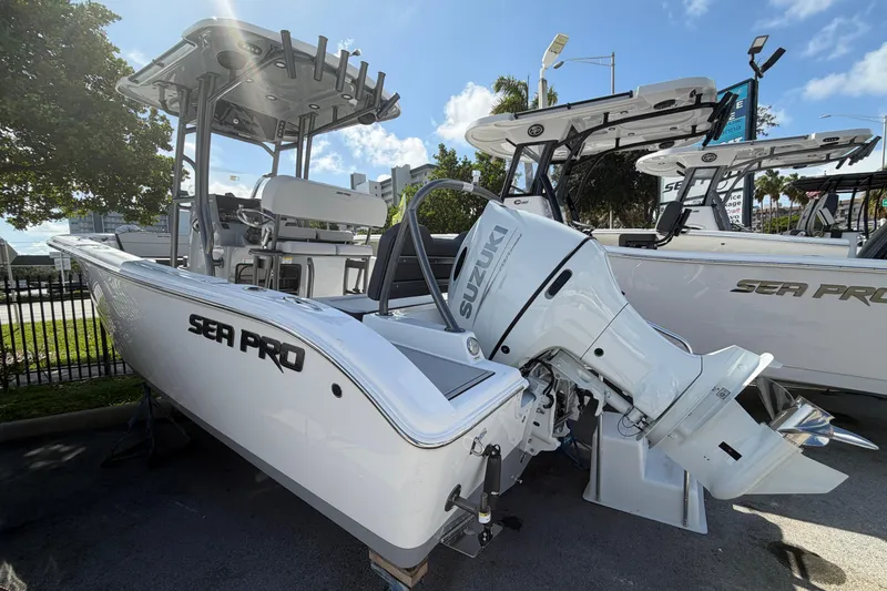 Slide: The Image of 2026 Sea Pro 225FLX Sandbar boat with Suzuki outboard motor, parked outdoors. - 5