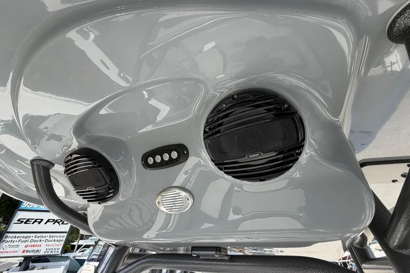Slide: The Image of 2026 Sea Pro 225FLX Sandbar boat speakers and controls on glossy surface. - 8