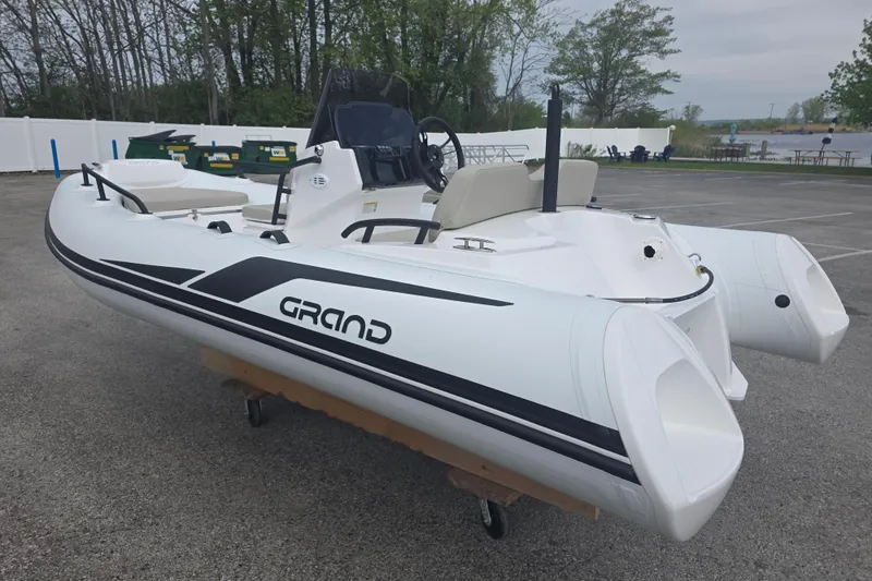 Slide: The Image of 2027 Grand Inflatables G420 boat on display in a parking lot. - 4