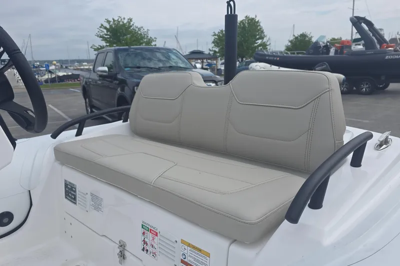 Slide: The Image of 2027 Grand Inflatables G420 boat seat, beige upholstery, parked near marina. - 8