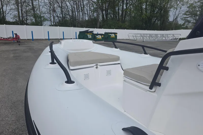 Slide: The Image of 2027 Grand Inflatables G420 boat with cushioned seating, parked outdoors. - 5